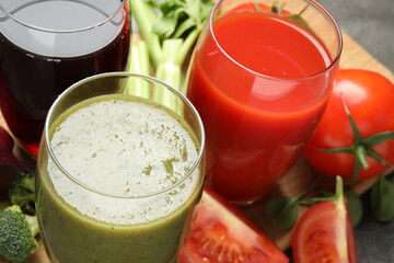 Delicious vegetable juices and fresh ingredients on table, closeup