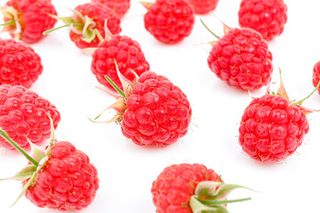 Pink ripe raspberries on a white background, juicy summer berries.