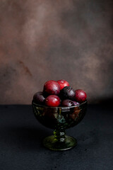 plums on a dark background