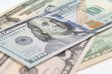 5, 20, 50, 100 dollars banknotes at different angles. Close up of dollars on white background.