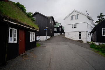 Old town of capital city of Torshavn. A narrow cobblestone street and typical wooden houses in...