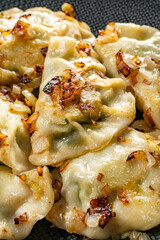 Fried dumplings (pierogi) with spinach.