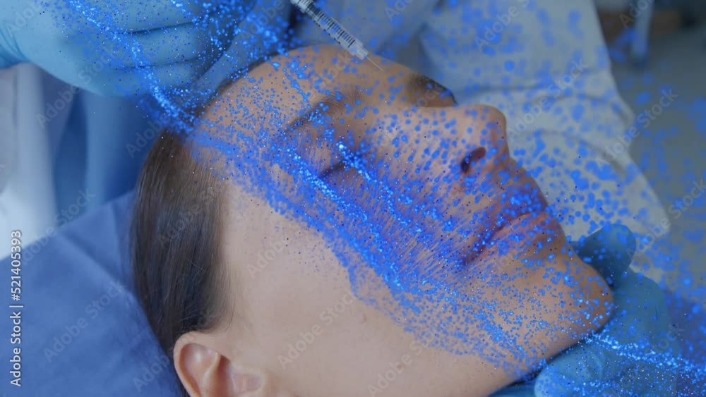 Poster Animation of network of blue particles over surgeon treating caucasian female patient