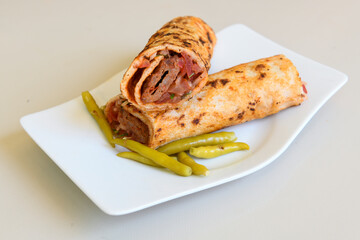 Grilled Turkish Adana, Urfa  Kebab with grilled vegetables, onion and rice on plate. Adana durum.