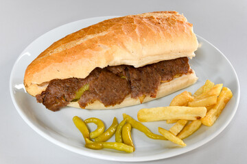 Turkish and Arabic Traditional Ramadan doner kebab with tasty tomato sauce and rice or turkish pilav in white plate on wood table background. ( , Iskender, ekmek arasi pilav ustu doner, doner durum )
