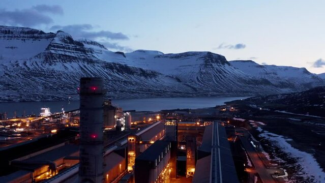 Large industrial facility at night with tall chimney, Rey&eth;arfj&ouml;r&eth;ur fjord, aerial