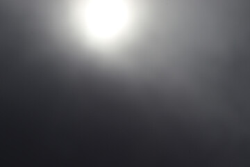 The sun shines in the fog.