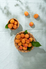 Fototapeta na wymiar resh apricots on the light green linen tablecloth