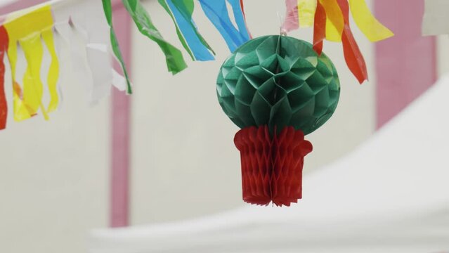 Colorful flags and figures blowing in the wind - they are used for decoration at the S&atilde;o Jo&atilde;o and Santos Populares in Lisbon and Porto, Portugal. This one is called Manjerico (Ocimum minimum).