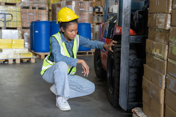 woman at work in storage warehouse wearing hard hat and hi visible vest not in good mood due to...