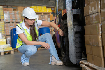 woman at work in storage warehouse wearing hard hat and hi visible vest not in good mood due to...