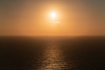 One single tiny cloud on the sunset sky