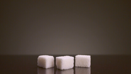 Pile of sugar cubes on isolated background. Stock footage. Pile of sugar cubes changes in number on isolated background. Sweets in large quantities are harmful to health. Sugar and sweets are 21st