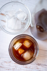 Top view of a glass cup with cold brew coffee on ice