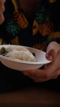 Eating Noam Angot Skor or Sticky Rice Dumplings