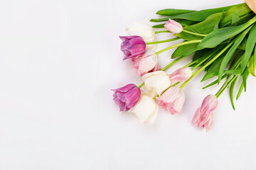 Bouquet of colorful tulips on a white wooden table, copy space.