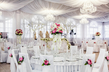 The table at the wedding banquet, served and decorated with floral arrangements