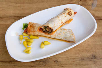 Lavash doner kebab ( doner zurna durum )  or shawarma sliced in plate isolated. 