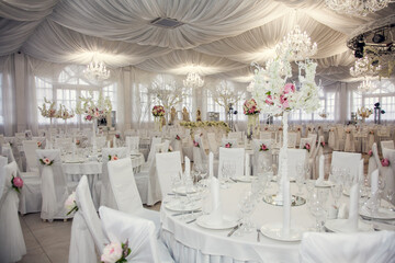 The table at the wedding banquet, served and decorated with floral arrangements