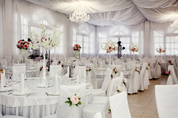 The table at the wedding banquet, served and decorated with floral arrangements