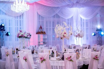 The table at the wedding banquet, served and decorated with floral arrangements