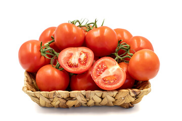 Bunch of tomatoes. Fresh tomatoes in basket isolated on white background. Organic food. close up