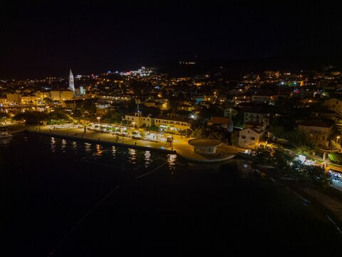 Aerial drone shot of the cityscape of Supetar, Brac, Croatia, at night