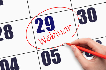 29th day of the month.  Hand writing text WEBINAR and circling the calendar date.
