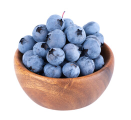Fresh blueberry in wooden bowl, isolated on white background. Bilberry or whortleberry. Clipping path.