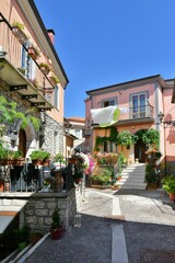 Fototapeta na wymiar A narrow street among the old houses of Greci, a village in the Campania region, Italy.
