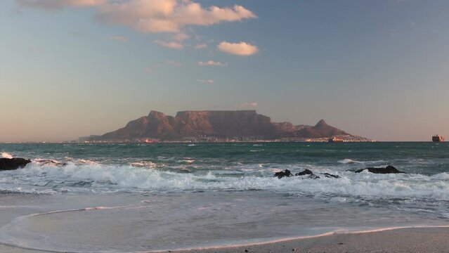 scenic view of tourist landmark destination table mountain cape town south africa from bloubergstrand with crushing waves