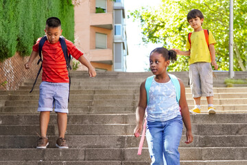 multiethnic kids with backpacks on the way to school.