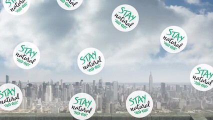 Animation of circles with stay natural text moving over aerial view of cityscape against cloudy sky - Powered by Adobe