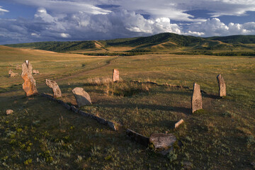 Ancient memorial complex of Safronovskie kurgans from stone menhirs stands in hilly steppe in...