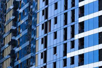 Facing the building with a ventilated facade. Aluminum colored facades. Modern facades of high-rise...
