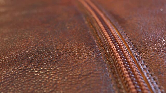 Slide shot macro texture and zip fasteners of a leather women's boot. Slow Dolly Shot.