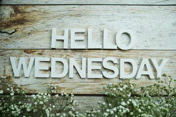 Hello Wednesday alphabet letters on wooden background