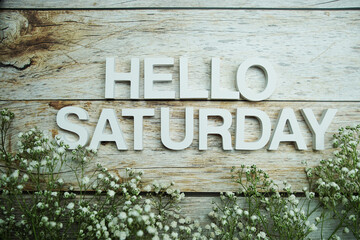 Hello Saturday alphabet letters on wooden background