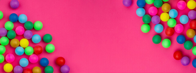 Abstract colored balls background. Multi-colored taw toy scattered on bright paper. Base for design nice backdrop, wallpaper, poster. Noisy surface texture
