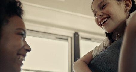 Two schoolgirls laughing sitting school bus close up. Teens chatting in vehicle 