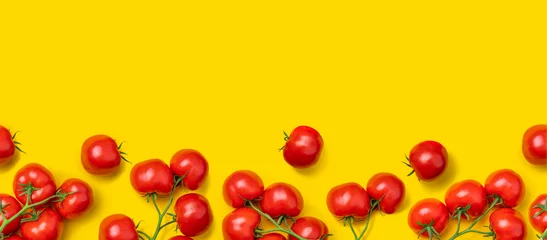 Fotobehang Tomato on a branch sprout top view flatlay on a yellow background. Fresh juicy ripe tomato Red Cherry fruits. Salad preparation ingredients. Empty copy space for mockup © TSViPhoto