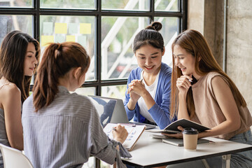 a group of successful business people in the conference room Asia Youth Team Startup Ideas: Meet young entrepreneurs brainstorm business plans and share ideas in a workshop.