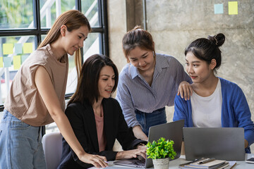 a group of successful business people in the conference room Asia Youth Team Startup Ideas: Meet young entrepreneurs brainstorm business plans and share ideas in a workshop.