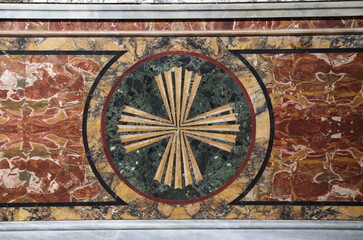 Fototapeta na wymiar Santa Maria in Transpontina Church Inlaid Marble Altar Front Detail with A Cross in Rome, Italy