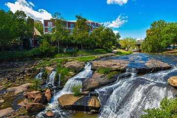 Waterfall against trees and buildings, Falls Park on the Reedy, Greenville, South Carolina