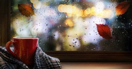 A cup of hot autumn coffee or tea on the window. Living in Hygge style. Hot drink in cold autumn...