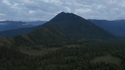 Obraz premium Aerial of majestic mountains in valley of Altai under sunset sky