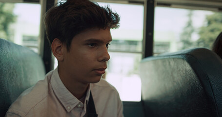 Indian teen boy sitting bus talking passenger close up. Teenager communicating.