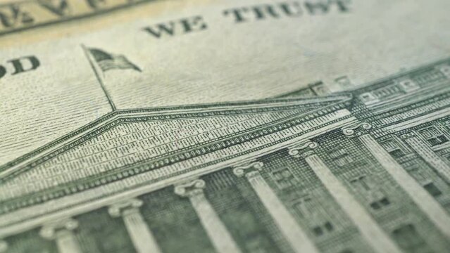 Slide shot of part of US dollar bills. Slow macro dolly shot. Detailed view of an American banknote. Fiat money concept, background.