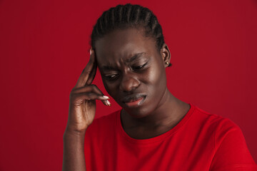 Obraz premium Young african woman with braided hair suffering from headache